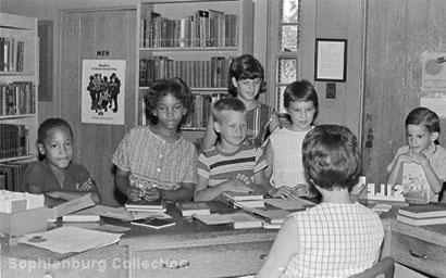 Photo: School children at the front desk in Emmie Seele Faust Memorial Library, corner of Coll and Magazine, circa 1965.