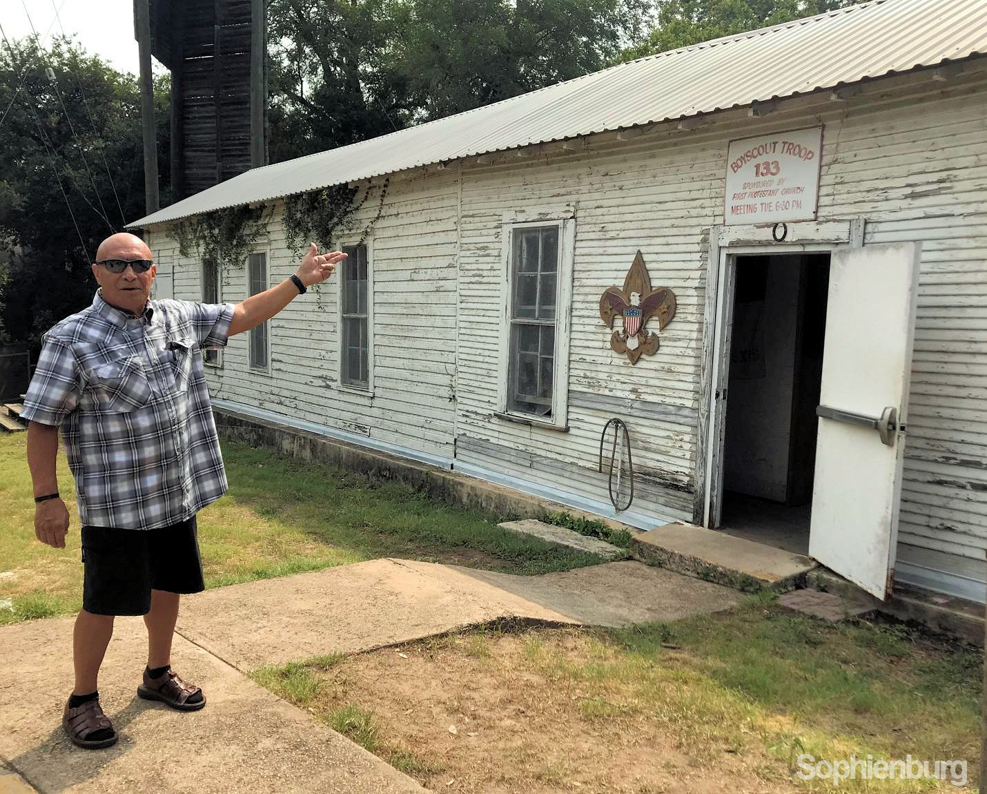 Juan Serda stands in front of the Troop 133 Scout Hut, historic school buildings (circa 1901-1950) that were relocated to Coll & Market in 1955. Serda remembers attending first grade in Mrs. Gillett’s class, and having math class in the old wooden structures.