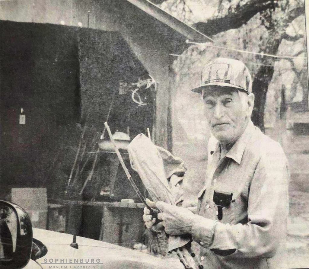Elmo Jonas in 1995. He is wrapping up his favorite switching rod made from a forked peach tree branch. Photo by Cynthia Cason.
