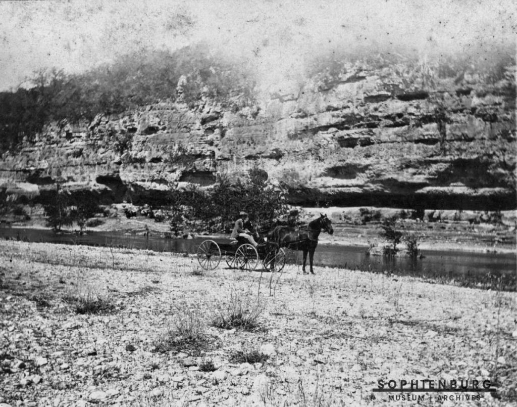 PHOTO CAPTION: Horse Drawn Wagon on River Road showing cliff and Guadalupe River, ca.1900.