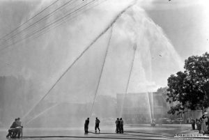 CAPTION: New Braunfels Volunteer Fire Department water displays, Fourth of July Celebration on Main Plaza ca.1950.